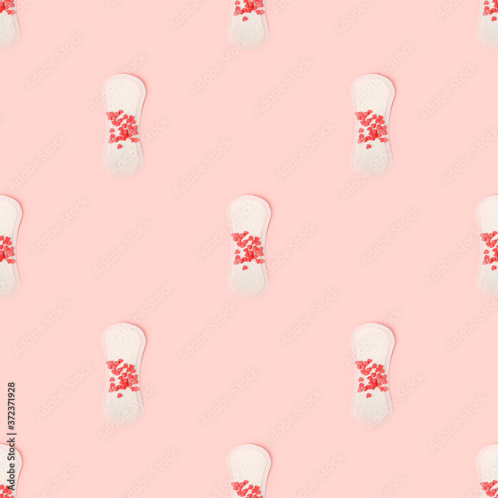 Seamless pattern with Sanitary Pads and confectionery coral heart on pink background, top view, flat lay. Concept of critical days, menstruation, printshop, contemporary monochrome background