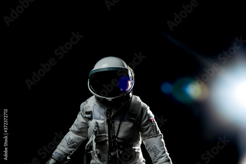Fototapeta Naklejka Na Ścianę i Meble -  astronaut with lens flares and black background