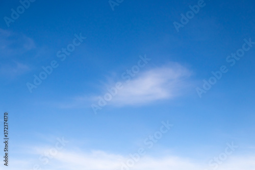 Clear blue sky with white cloud background © bankrx