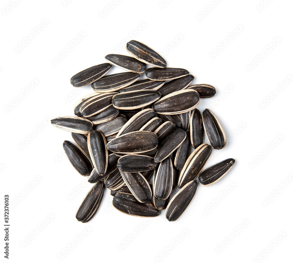 Closeup of black sunflower seeds isolated on white background. Pile of sunflower seeds isolated with clipping path Closeup of black sunflower seeds isolated on white background. Pile of sunflower seeds isolated with clipping path