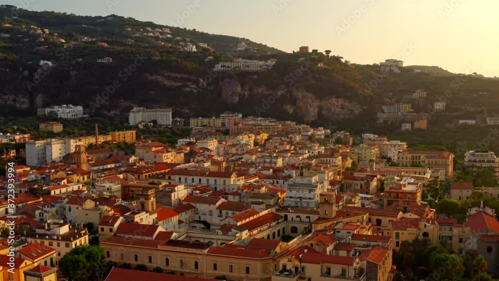 Aerial Drone View of Sorrento Town at Sunset.
Warm Scenic View The Old Historic Italian Town near Naples.
Summer Holidays and travel City.