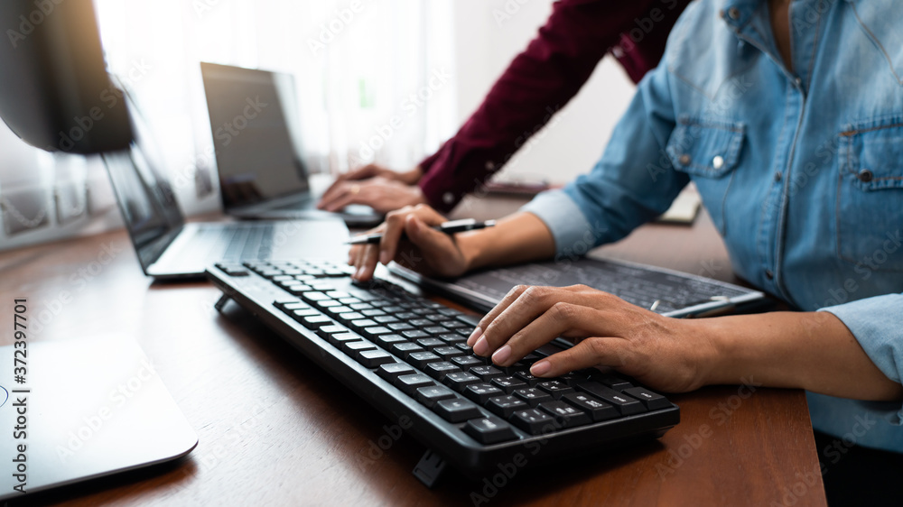 Team of Programmer working to find solution to problem and coding technologies in a software developing company office. Team of Programmer working to find solution to problem and coding technologies in a software developing company office.