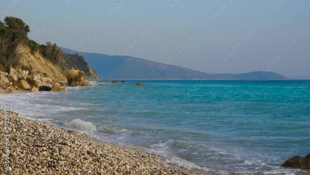 Paradise rocky beach with no people on rocky coastline of Ionian sea with blue turquoise water Paradise rocky beach with no people on rocky coastline of Ionian sea with blue turquoise water
