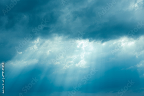 Sunrays Through Blue Rainy Dramatic Sky. Natural Abstract Background © Grigory Bruev