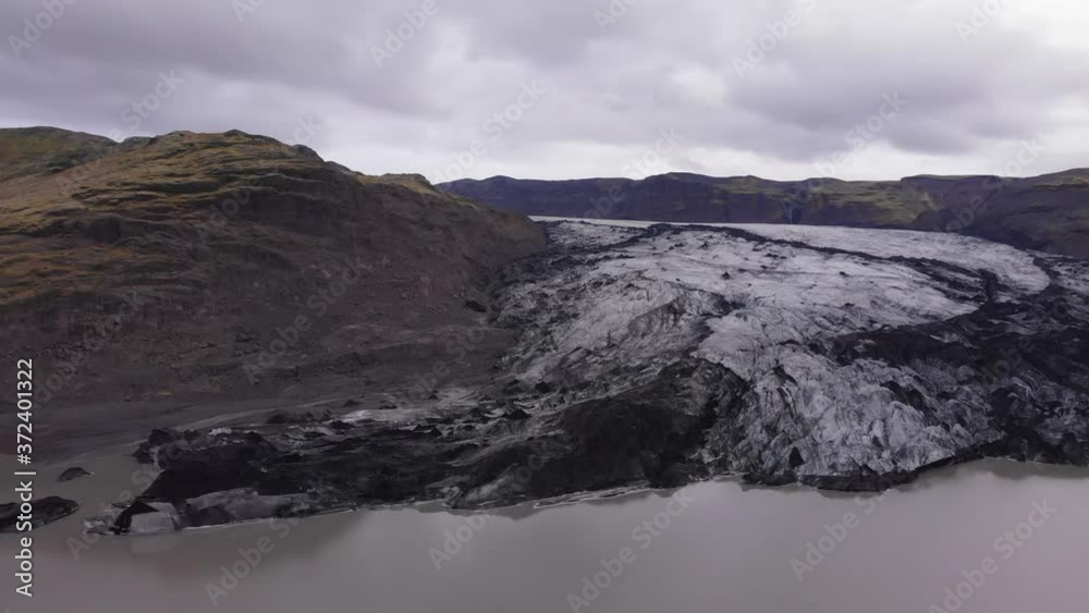 Aerial images flying over a glacier and its glacier lagoon. Panning to the left reveals a river joining the glacier lagoon. Aerial images flying over a glacier and its glacier lagoon. Panning to the left reveals a river joining the glacier lagoon.