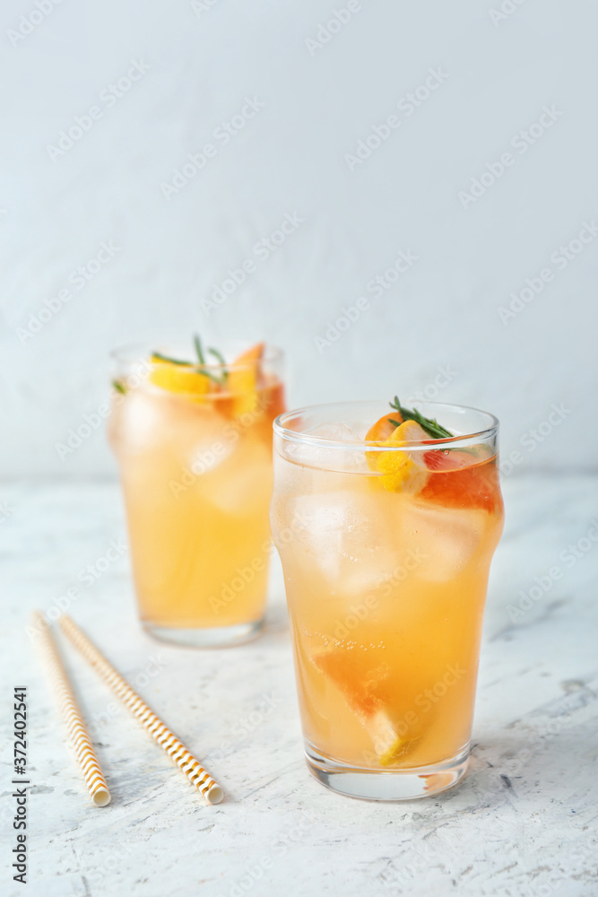 Fototapeta premium Glasses of fresh grapefruit juice on white background