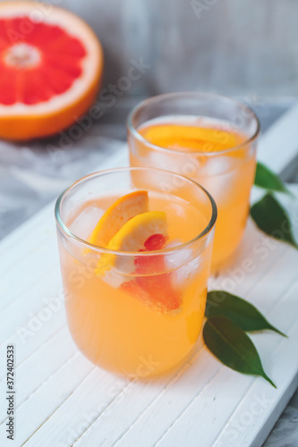 Glasses of fresh grapefruit juice on table