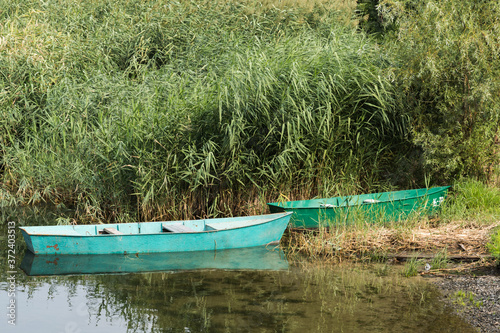 Fototapeta Naklejka Na Ścianę i Meble -  Old boats standing by the river Bank