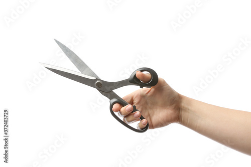 Female hand with tailor's scissors on white background