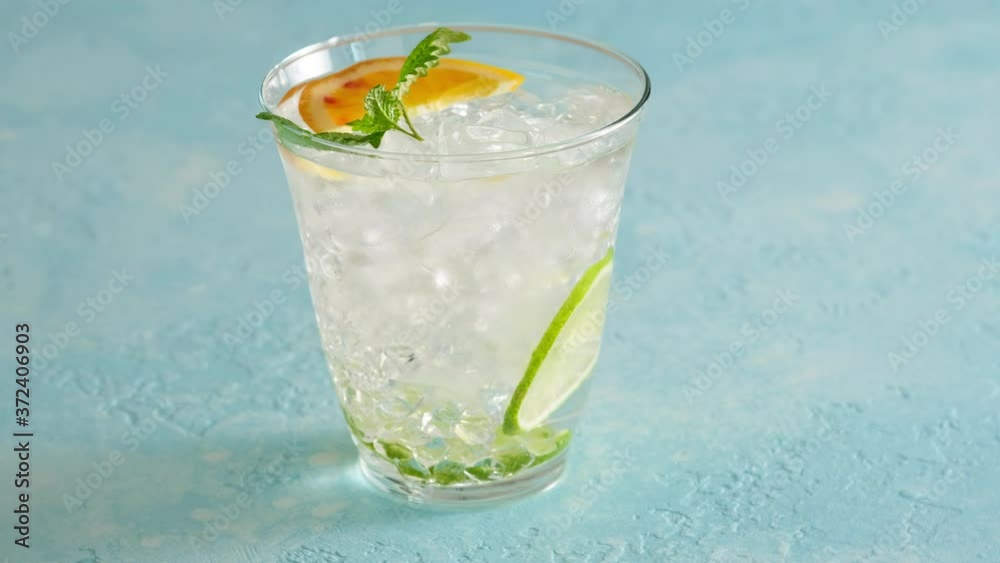 Glass with soda water, lime, orange and ice. A refreshing cocktail. Summer. Heat. Mint. Glass with soda water, lime, orange and ice. A refreshing cocktail. Summer. Heat. Mint.