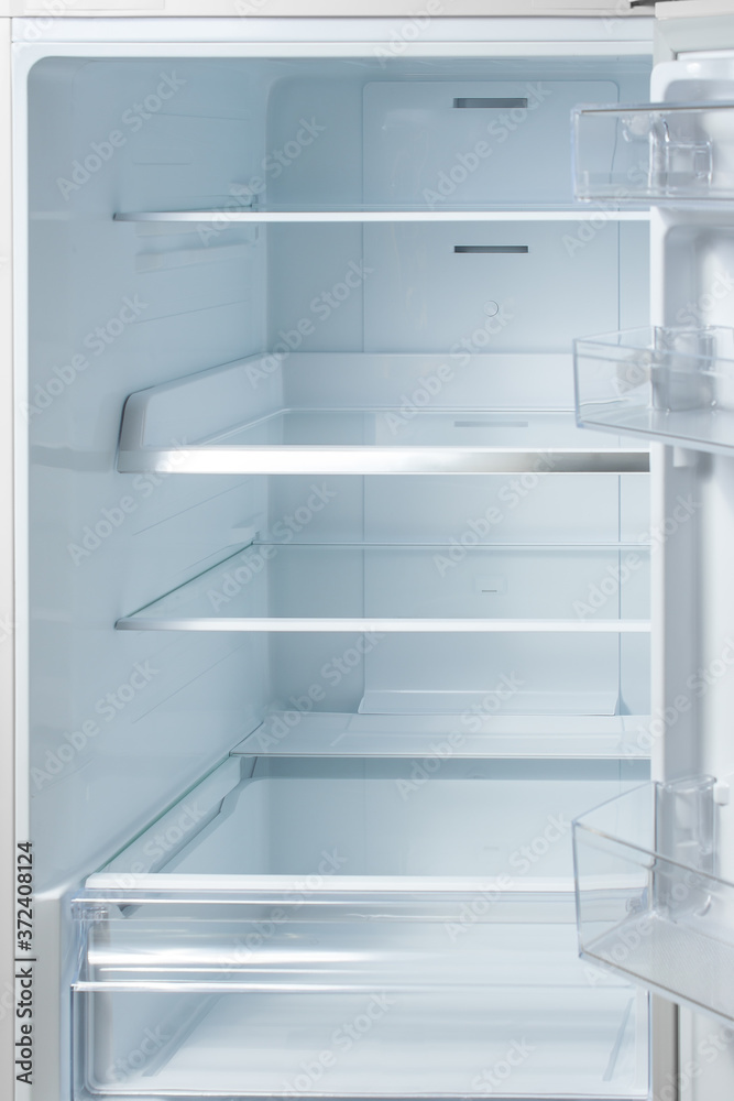 New white refrigerator. Empty shelves in fridge. background for health or diet concept. New white refrigerator. Empty shelves in fridge. background for health or diet concept.