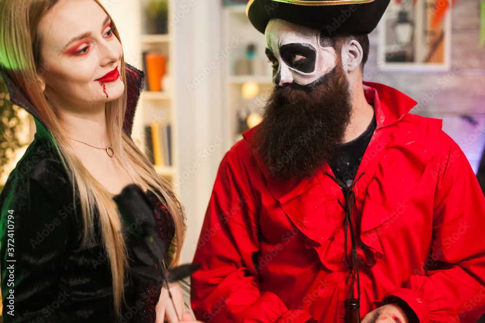 Man dressed up like a pirate trying to seduce vampire woman at halloween party. Man dressed up like a pirate trying to seduce vampire woman at halloween party.