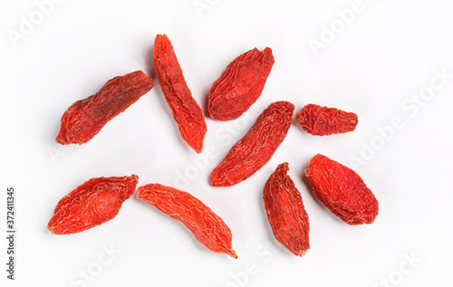 Closeup photo of nine goji berry (wolfberry - Lycium chinense) dried fruits isolated on white background, view from above
