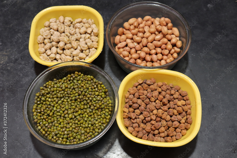 Fresh green gram beans and peanuts with channa dal on black background Fresh green gram beans and peanuts with channa dal on black background