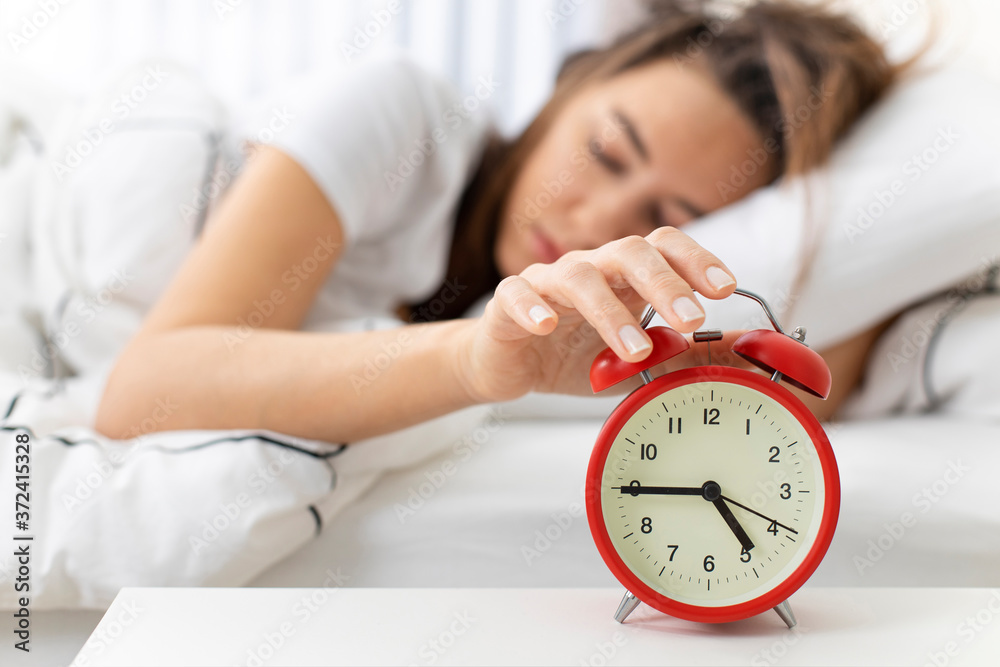 Wake up of an asleep woman stopping alarm clock Wake up of an asleep woman stopping alarm clock