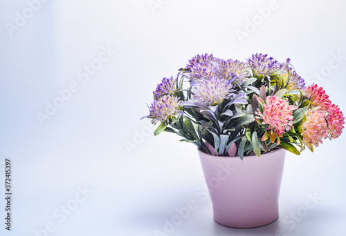 Colorful flowers bouquet in a vase on a gray background. Valentine card. Template greeting card for Valentine's Day. Spring card for Mother's Day or Women's Day. Greeting card with flowers, copy space