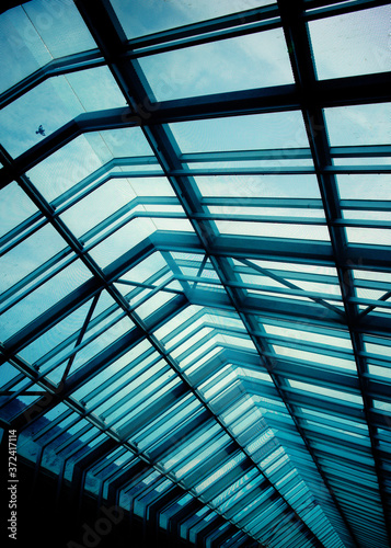 Roof structure. Building abstract. A bird flying over glass roof. Toned image.