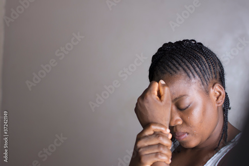 A young African girl in pains, crying.   photo