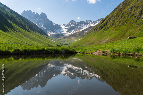 Reflection of Chauki mountain in Juta valley, Caucasus mountain range in summer season, Georgia