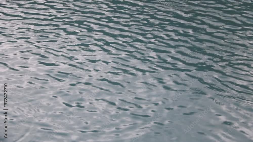 Rain drops on water from start of a powerful storm Rain drops on water from start of a powerful storm