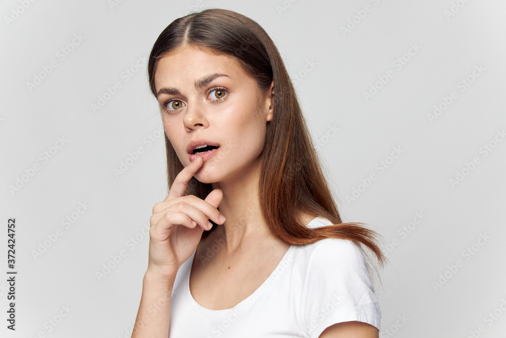 Puzzled look of woman with finger near lips Puzzled look of woman with finger near lips