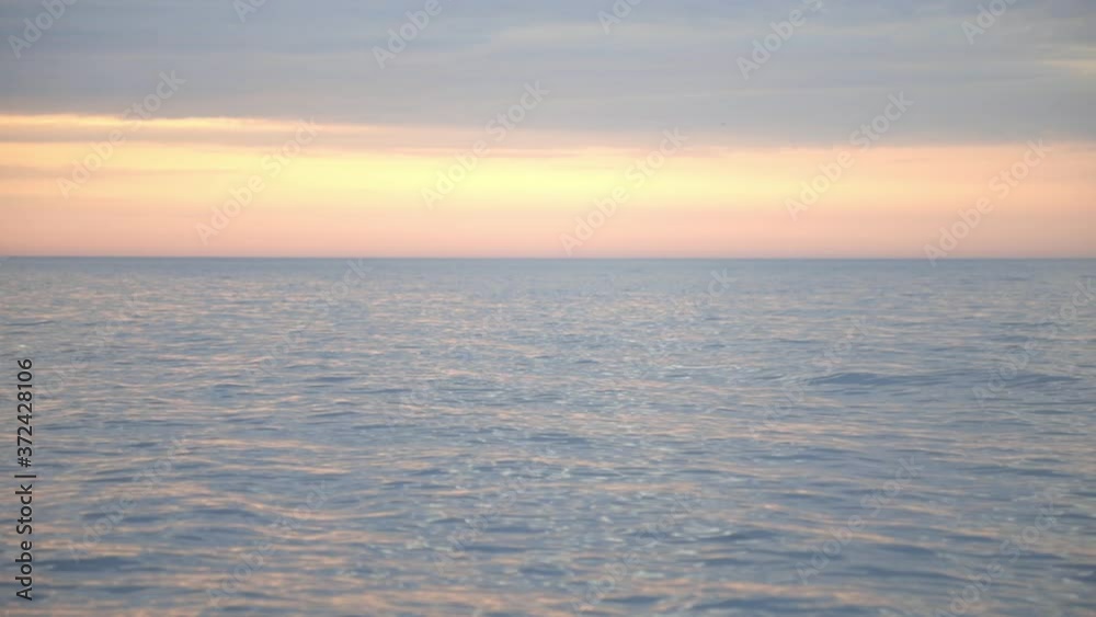 Tranquil And Inviting Scenery Of The Ocean During Sunset - wide shot Tranquil And Inviting Scenery Of The Ocean During Sunset - wide shot
