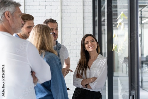 Business people meeting at office and use post it notes to share idea. Brainstorming concept. Sticky note on glass wall. Free Download Business people meeting at office and use post it notes to share idea. Brainstorming concept. Sticky note on glass wall. - GFXLoad