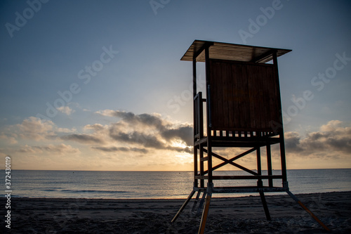 A lifeguard tower during sunrise