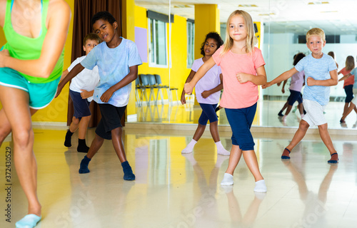 Emotional children performing modern dance in fitness studio. High quality photo