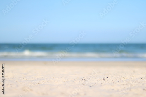 A photo of blurry calm tropical beach in sunny windy warm day