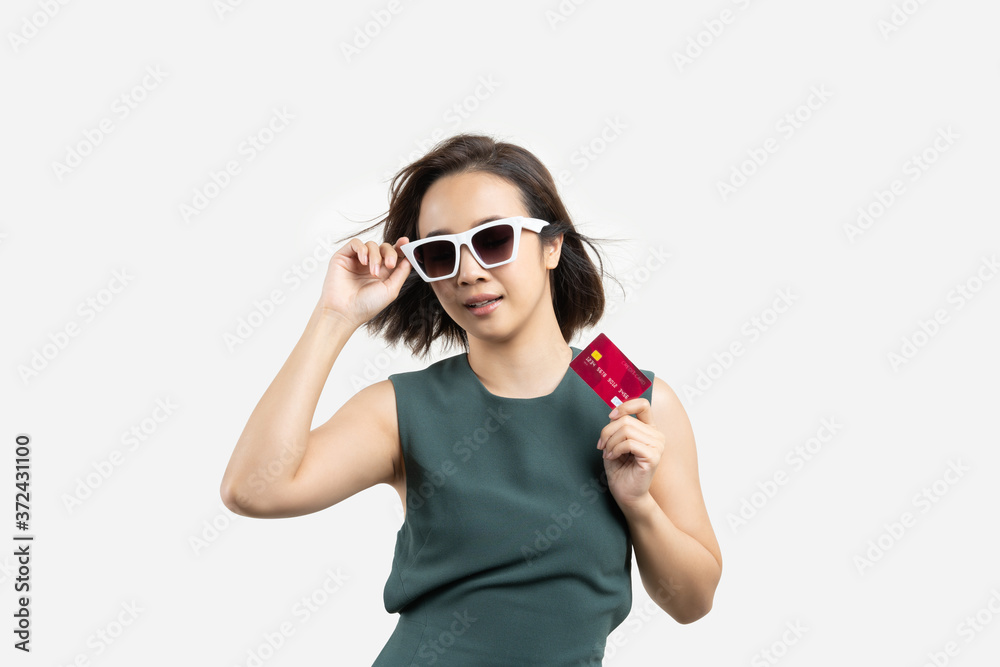 Young beauty Asian woman wearing sunglasses and showing credit card blank card on white isolate background. fashion shopping concept