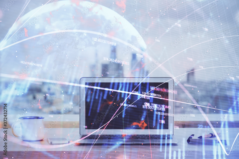 Stock market chart hologram drawn on personal computer background. Multi exposure. Concept of investment. Stock market chart hologram drawn on personal computer background. Multi exposure. Concept of investment.