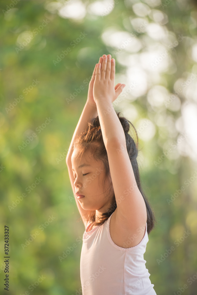 calmness and relax, female happiness.Horizontal, blurred background. little asian girl meditates while practicing yoga. freedom concept. calmness and relax, child happiness. toned picture healthy life calmness and relax, female happiness.Horizontal, blurred background. little asian girl meditates while practicing yoga. freedom concept. calmness and relax, child happiness. toned picture healthy life