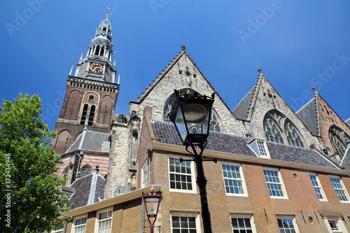 Oude kerk church, located along Oudezijds Voorburgwal canal in Amsterdam, Netherlands photo