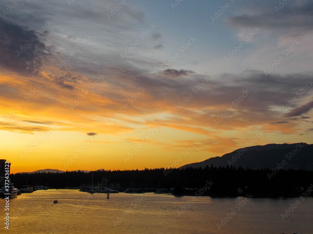 Beautiful yellow sunset over Stanley Park in Vancouver in September.