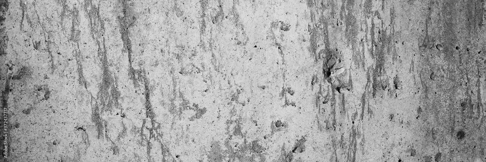 Texture of old cracked concrete wall. Rough gray concrete surface. Wide panoramic background for design.