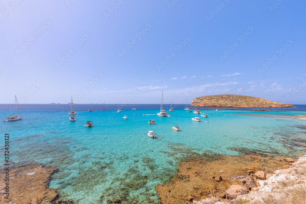 The cleanest turquoise sea off the coast Cala Escondida. Ibiza, Balearic Islands. Spain