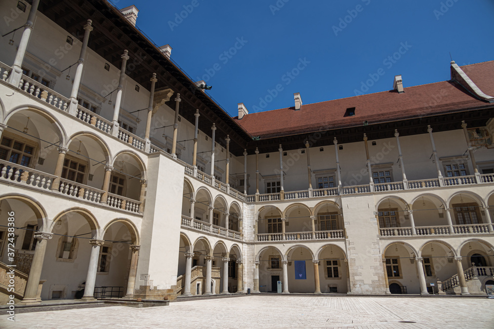 without people courtyard with arcades at the Wawel Royal Castle in Krakow, Poland on a sunny summer day