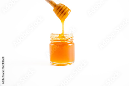 honey and honey in jar on white background