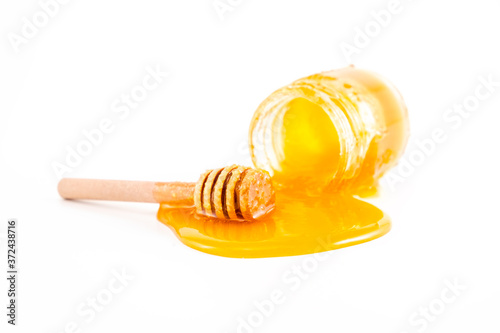 honey and honey in jar on white background