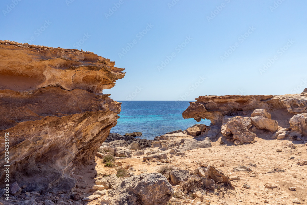 Small hidden rocky cove off the coast of the Ibiza island. Balearic Islands, Spain