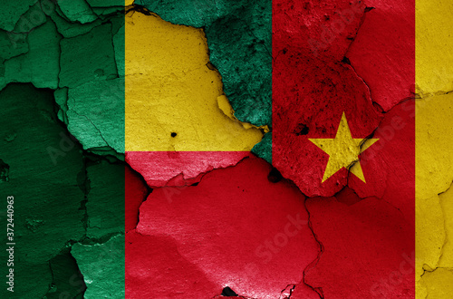 flags of Benin and Cameroon painted on cracked wall