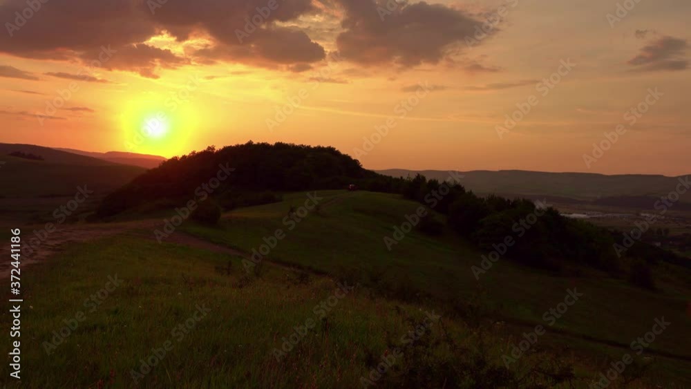 off road car through hill at sunset off road car through hill at sunset