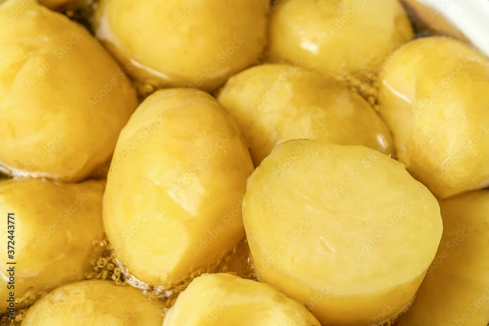 Beautiful, yellow potatoes cooking in a pot close-up