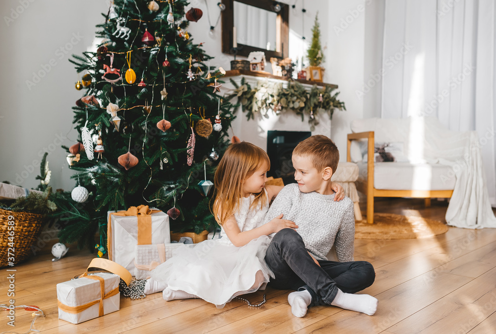 Little sister presents a gift to her brother.