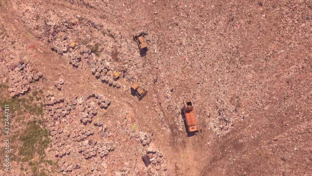 Bird's eye view of a garbage dump where machinery equals mountains of household waste, Ukraine. Ecological problem Bird's eye view of a garbage dump where machinery equals mountains of household waste, Ukraine. Ecological problem