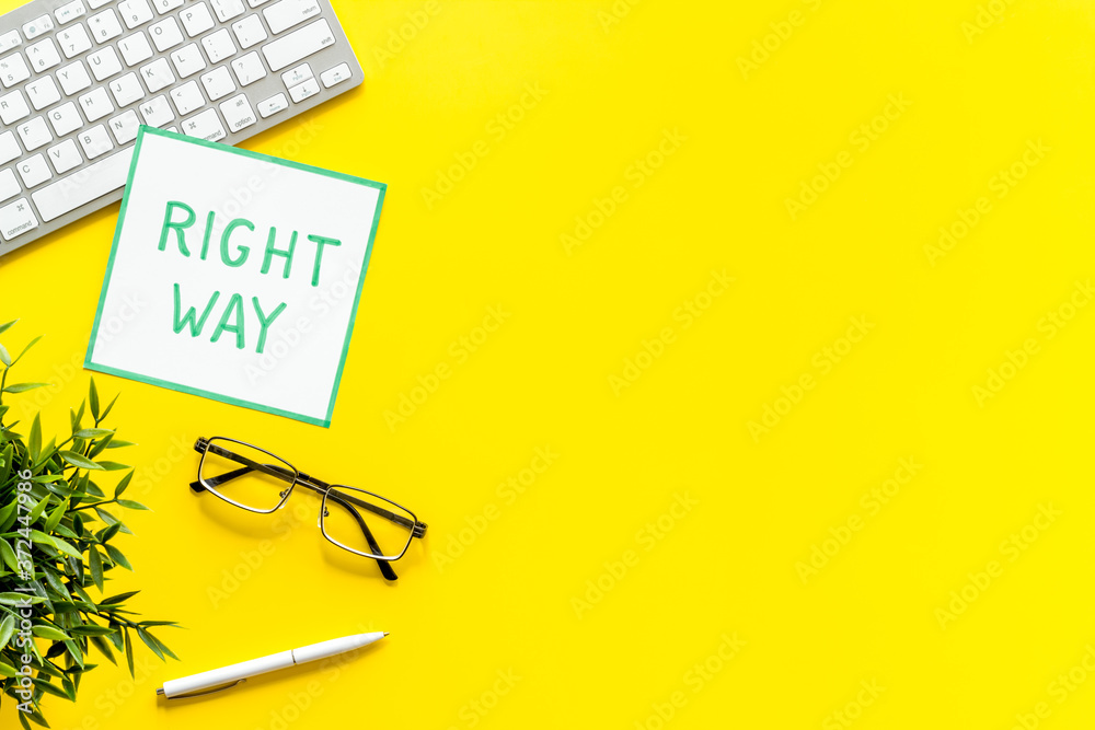 Right way icon on yellow office desk top view copy space Right way icon on yellow office desk top view copy space
