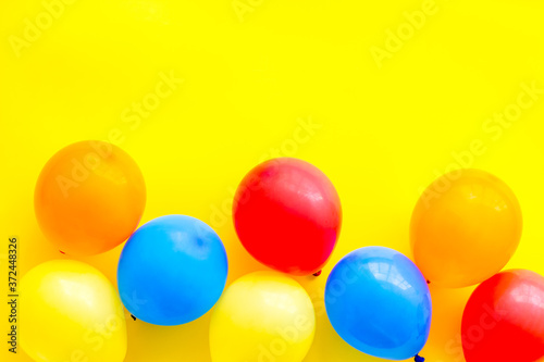 Happy birthday concept. Balloon on yellow background top-down copy space