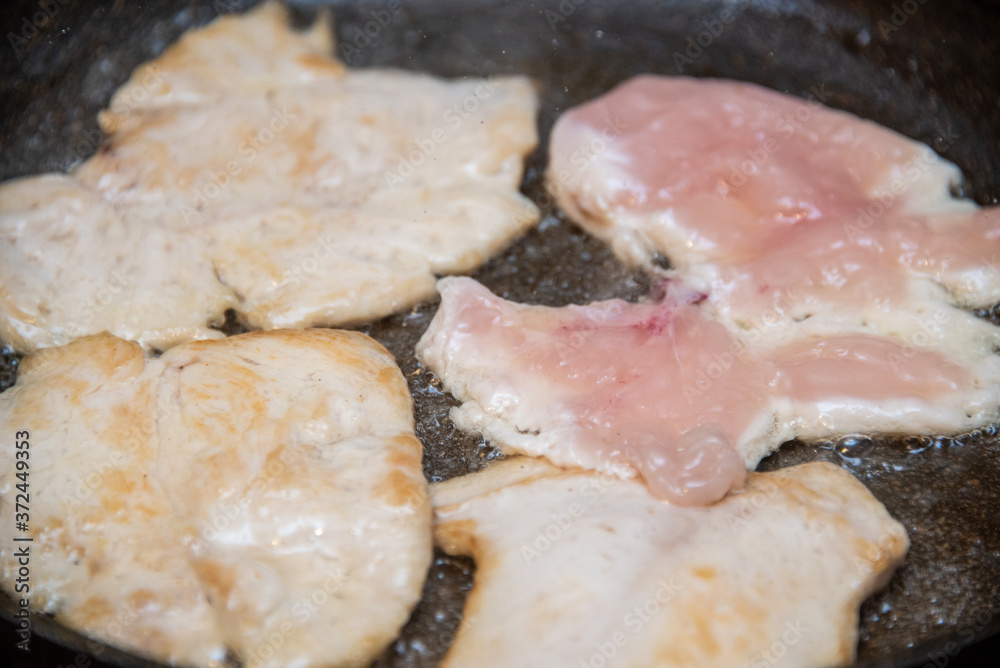 Chicken fillet fried in oil in a pan Chicken fillet fried in oil in a pan