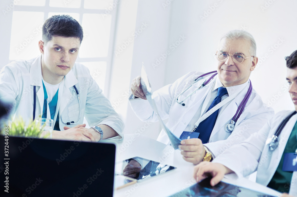 Medical team sitting and discussing at table Medical team sitting and discussing at table